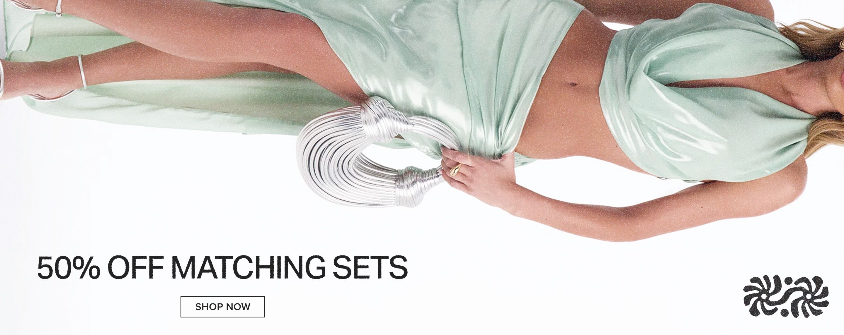 Model showcases a flowing mint green matching set and unique silver bag. Shop 50% off stylish matching sets now.