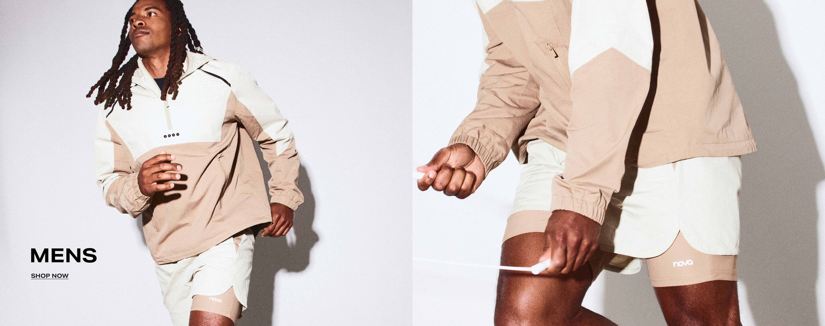 Man running in a beige and cream color-block windbreaker jacket. Promo banner for mens athletic apparel with MENS and SHOP NOW text.