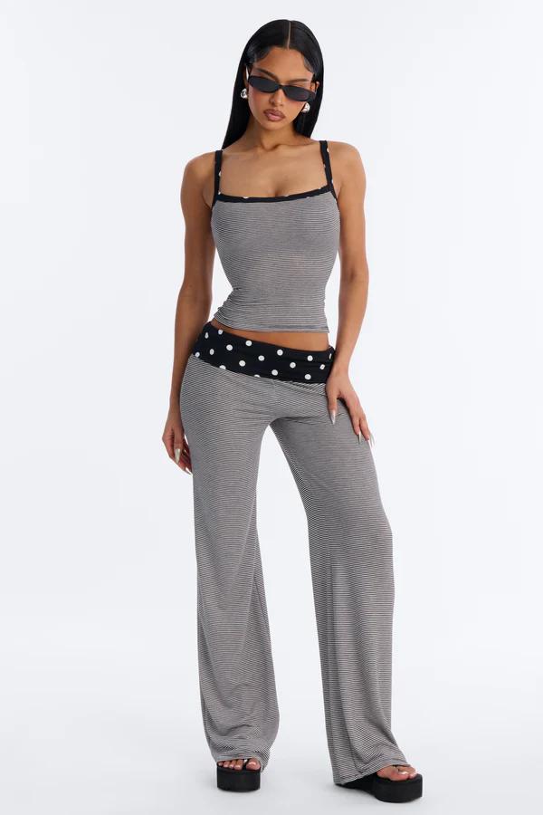 Model wears a stylish grey striped crop top and wide-leg pants matching set, with a chic polka-dot waistband. Ideal for trendy loungewear.
