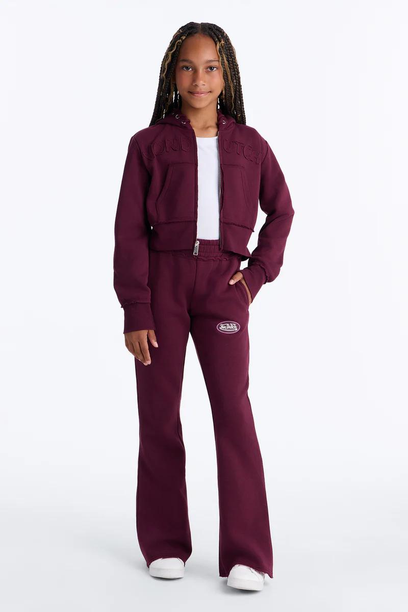 Girls burgundy Von Dutch tracksuit featuring a cropped zip-up hoodie and matching flare sweatpants.
