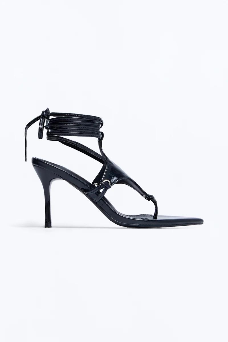 Black lace-up stiletto heel sandals with ankle tie straps and pointed toe.