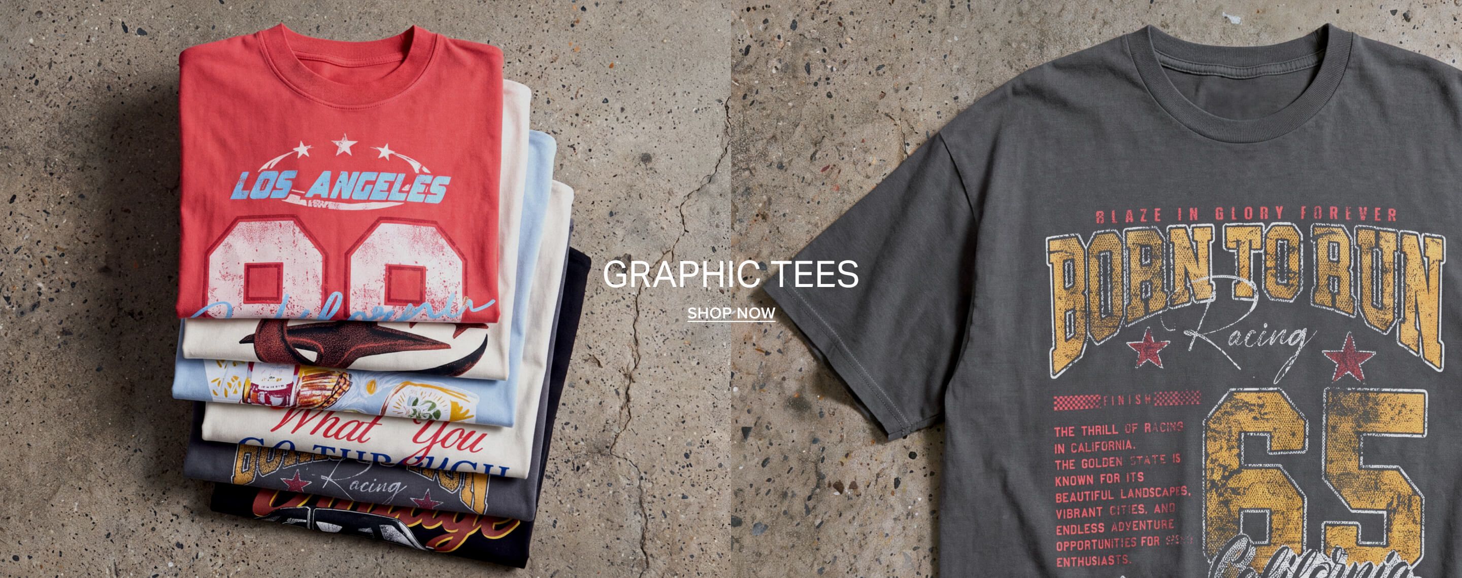 Stacked graphic tees in coral, blue, and cream on concrete, featuring LA and racing designs. Shop our diverse collection of graphic t-shirts.