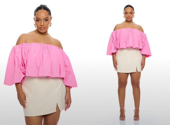 Model in a voluminous pink off-shoulder ruffle top and beige mini skirt with slit. Promoting a trendy women's spring/summer outfit.