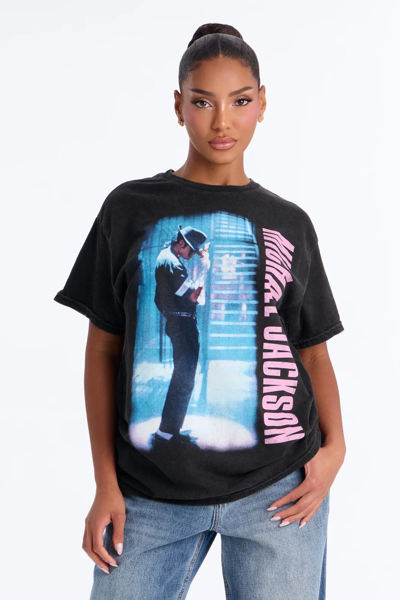 Woman in a black vintage Michael Jackson graphic t-shirt and jeans.