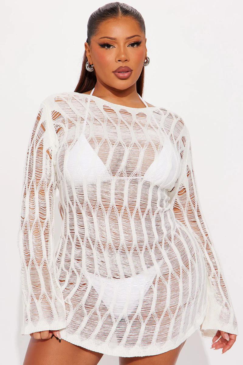 Plus size woman in white distressed knit long sleeve cover-up over bikini. Perfect for beach & resort swimwear fashion.