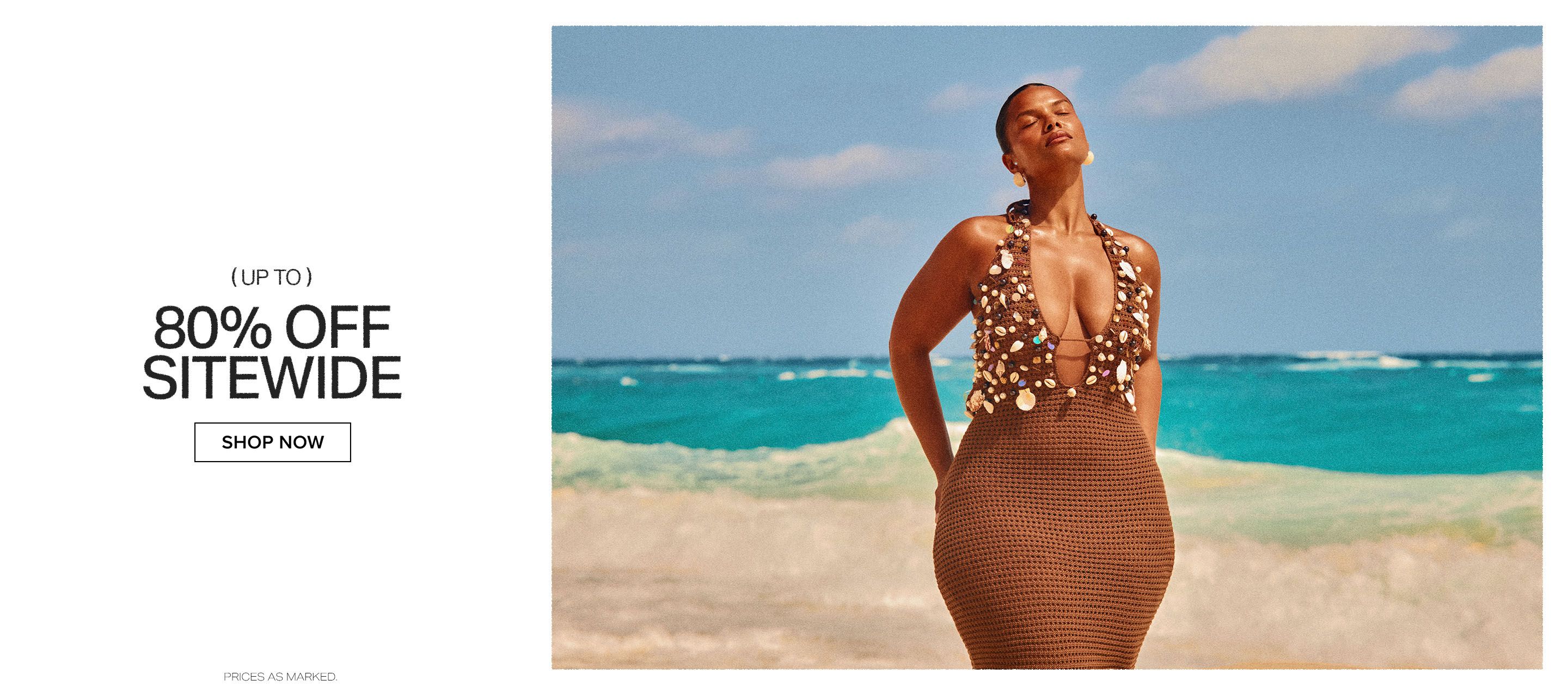 Radiant woman in a brown, shell-adorned crochet beach dress by the turquoise ocean, promoting 80% off sitewide summer sale. Shop now!