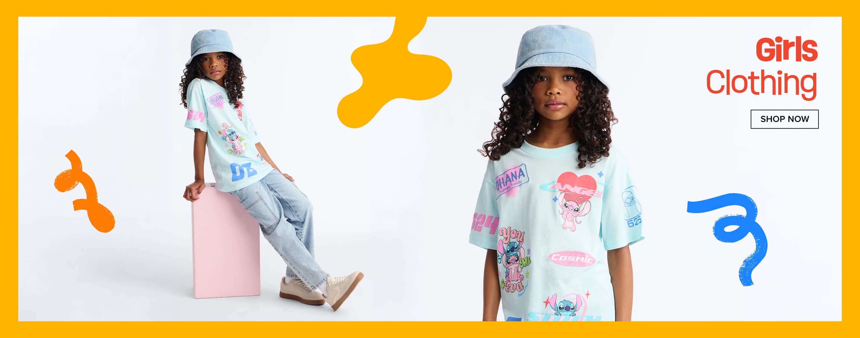 Young girl in light blue Stitch tee, light wash denim cargo pants, and bucket hat, leaning on pink block. Promotes girls' clothing.