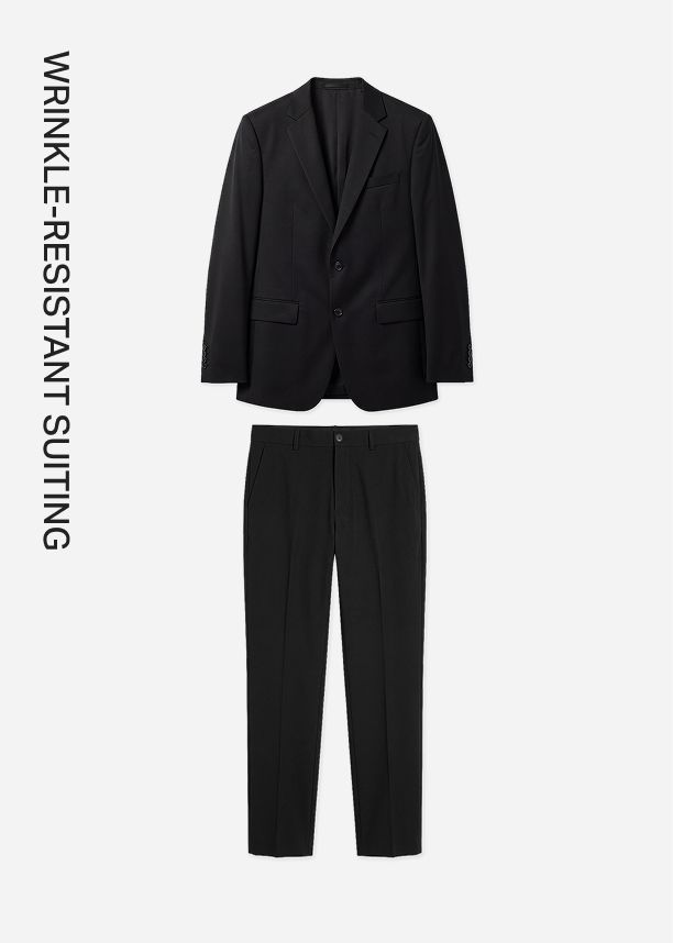 Tailored black wrinkle-resistant suit jacket and matching trousers flat lay, promoting a low-maintenance, travel-friendly men's wear collection.