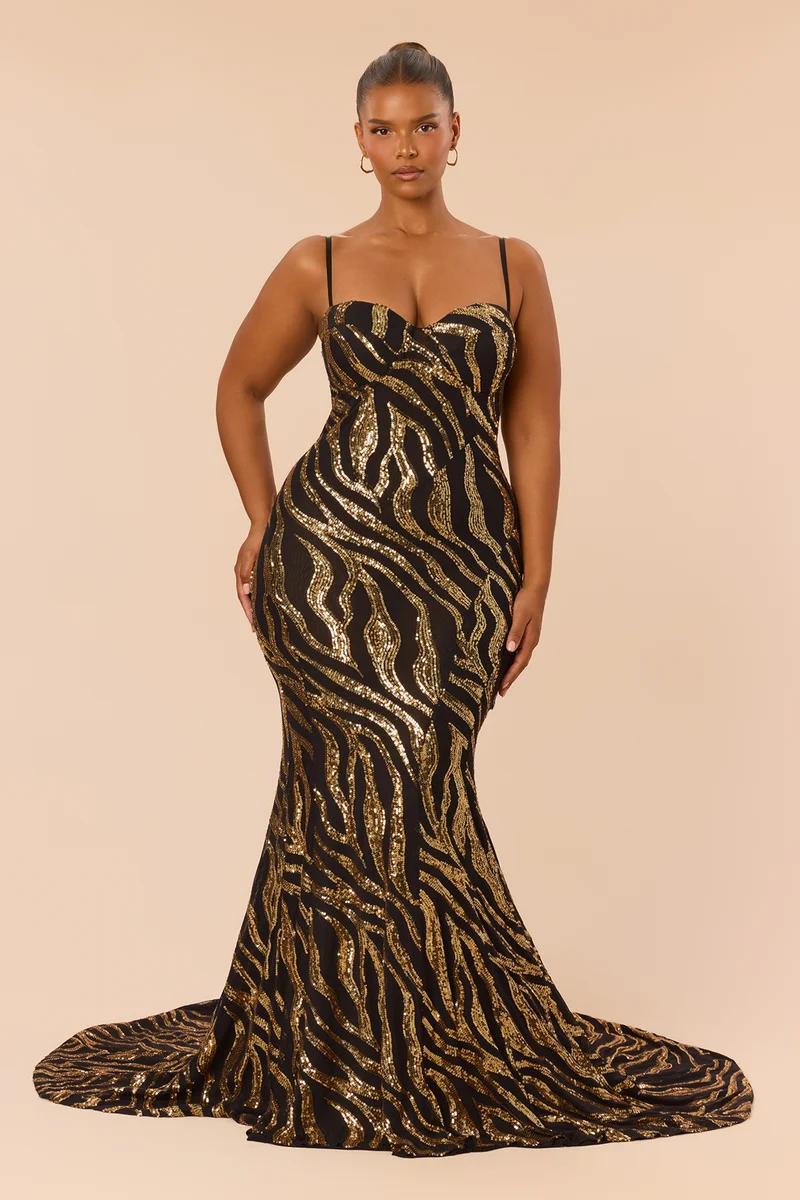 Model wears a fitted black and gold sequin zebra print floor-length evening gown, highlighting the luxury formal wear collection.