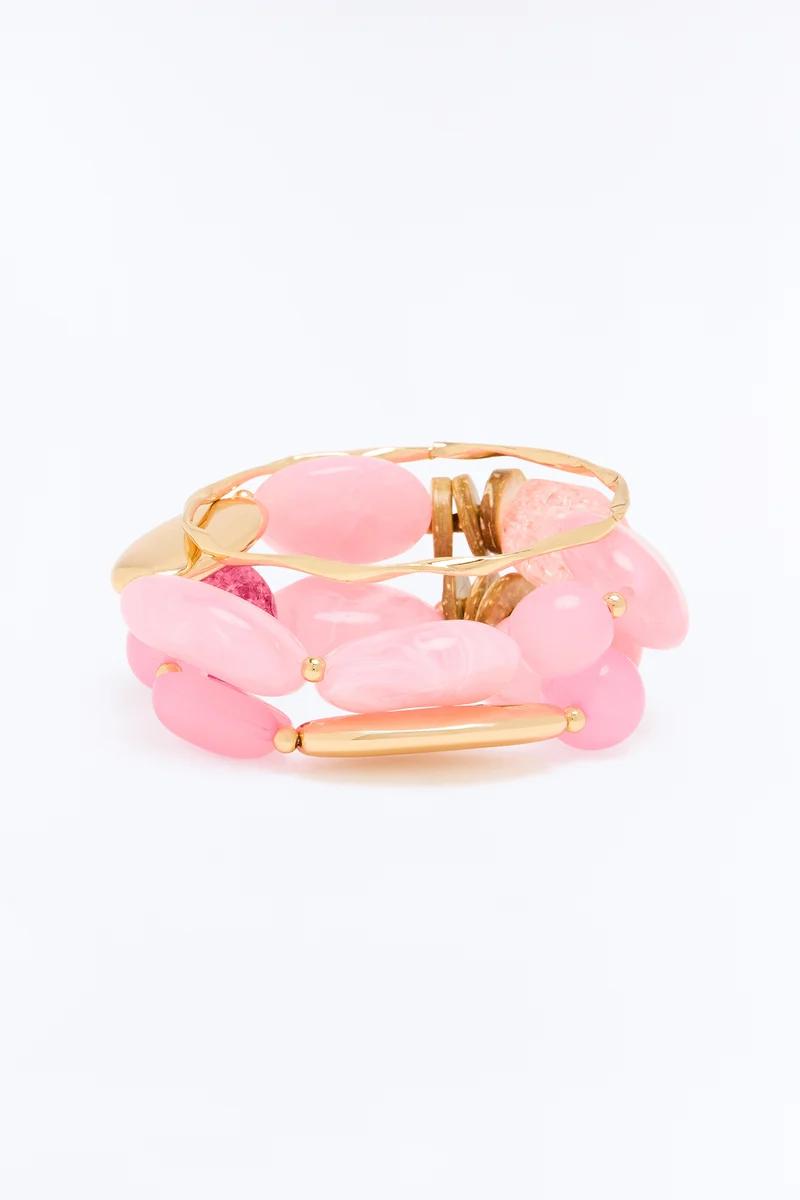 Multi-strand pink stone and gold cuff bracelet with smooth oval beads.