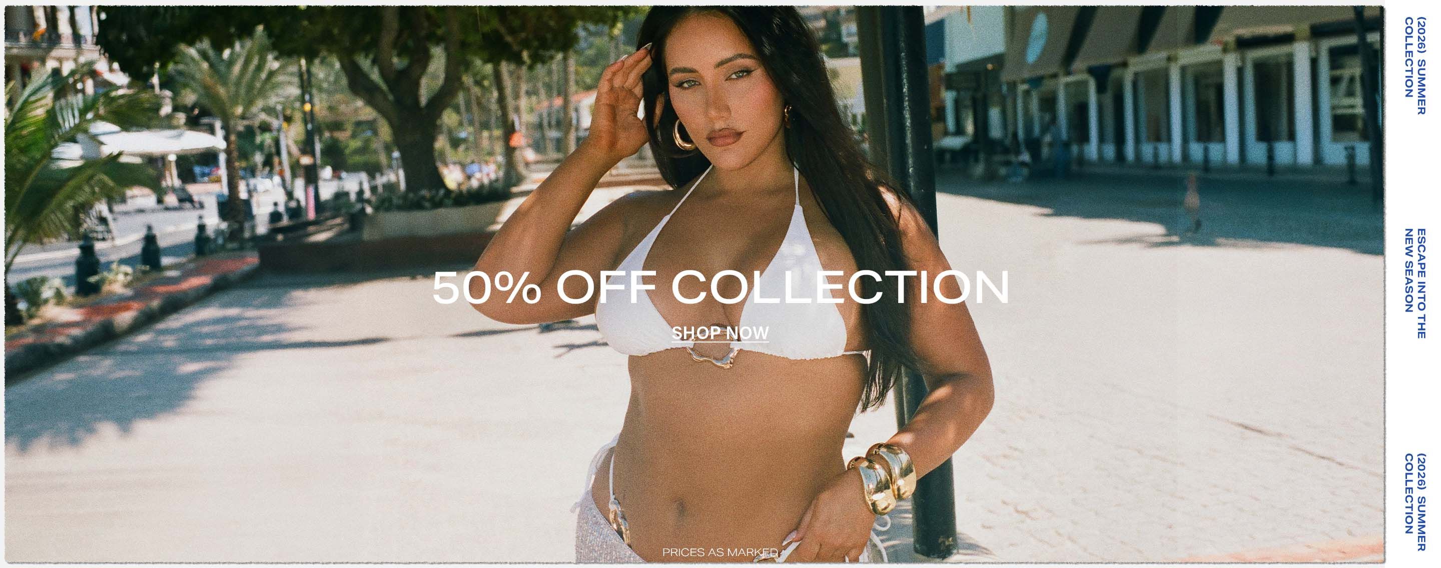 Woman in white bikini with gold hardware and sparkly silver skirt on a sunny beach, promoting 50% off summer collection. Shop now!