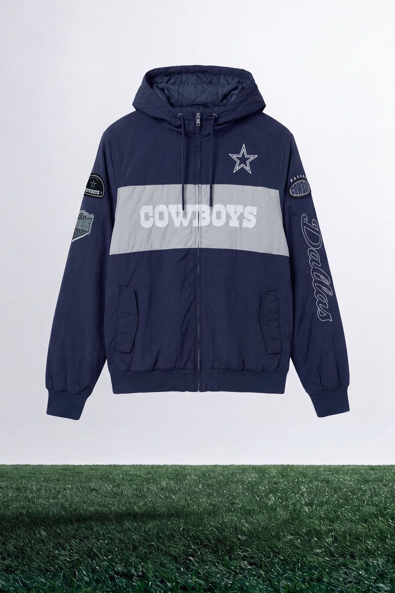 Navy blue and grey Dallas Cowboys hooded jacket with white star logo and chest banner showcased above green grass field apparel display.
