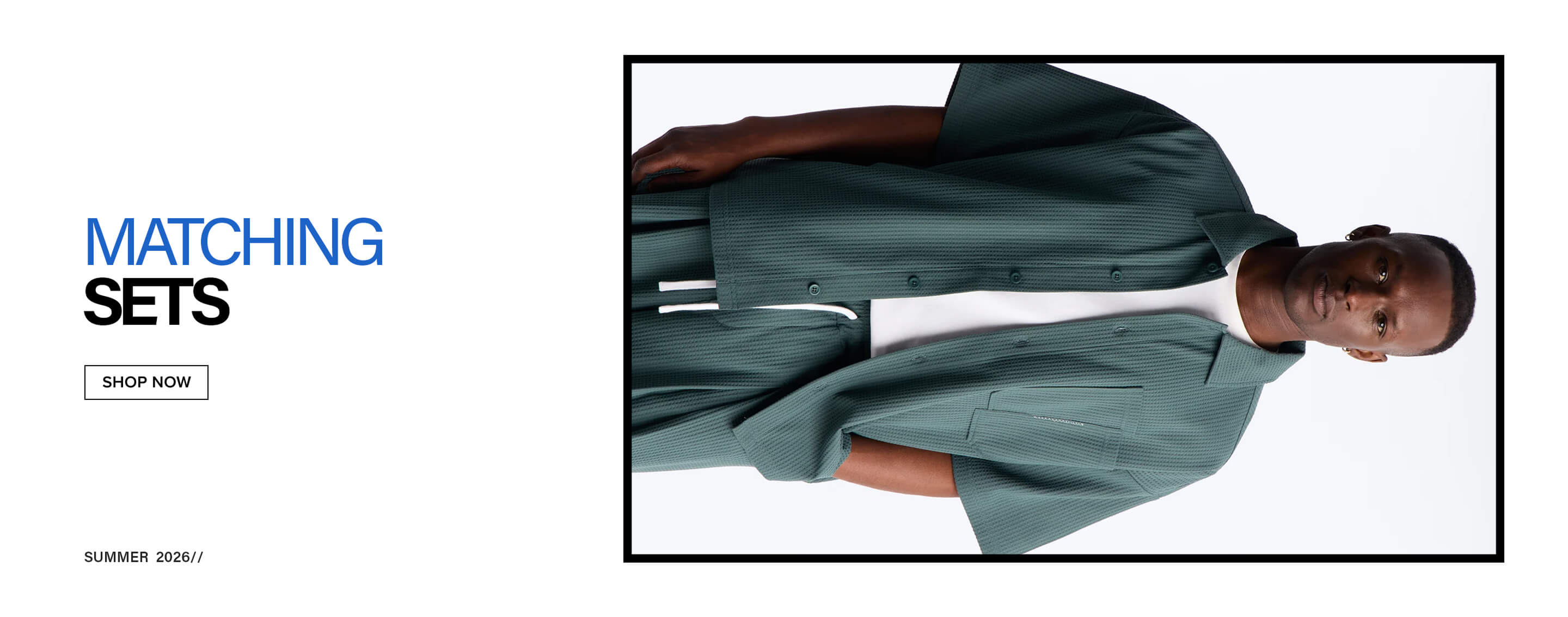 Man in dark green textured short-sleeve shirt over white tee and matching shorts, promoting new summer sets. Shop now.