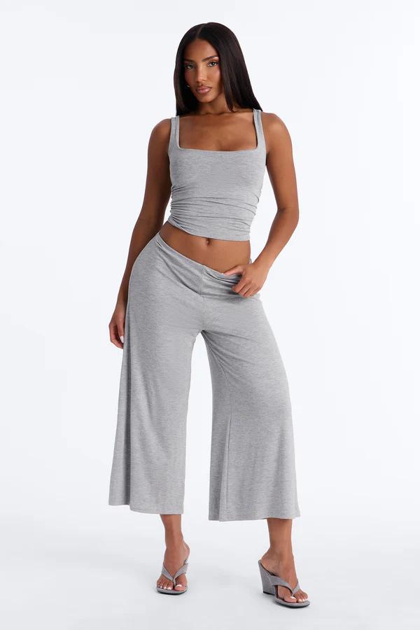 Woman wearing a chic gray square-neck crop tank and wide-leg lounge pants, highlighting our new comfortable two-piece casual set.
