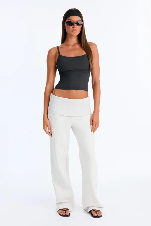 Model wears a black crop tank and white fold-over waist lounge pants, showcasing a Y2K aesthetic from the new casual summer collection.