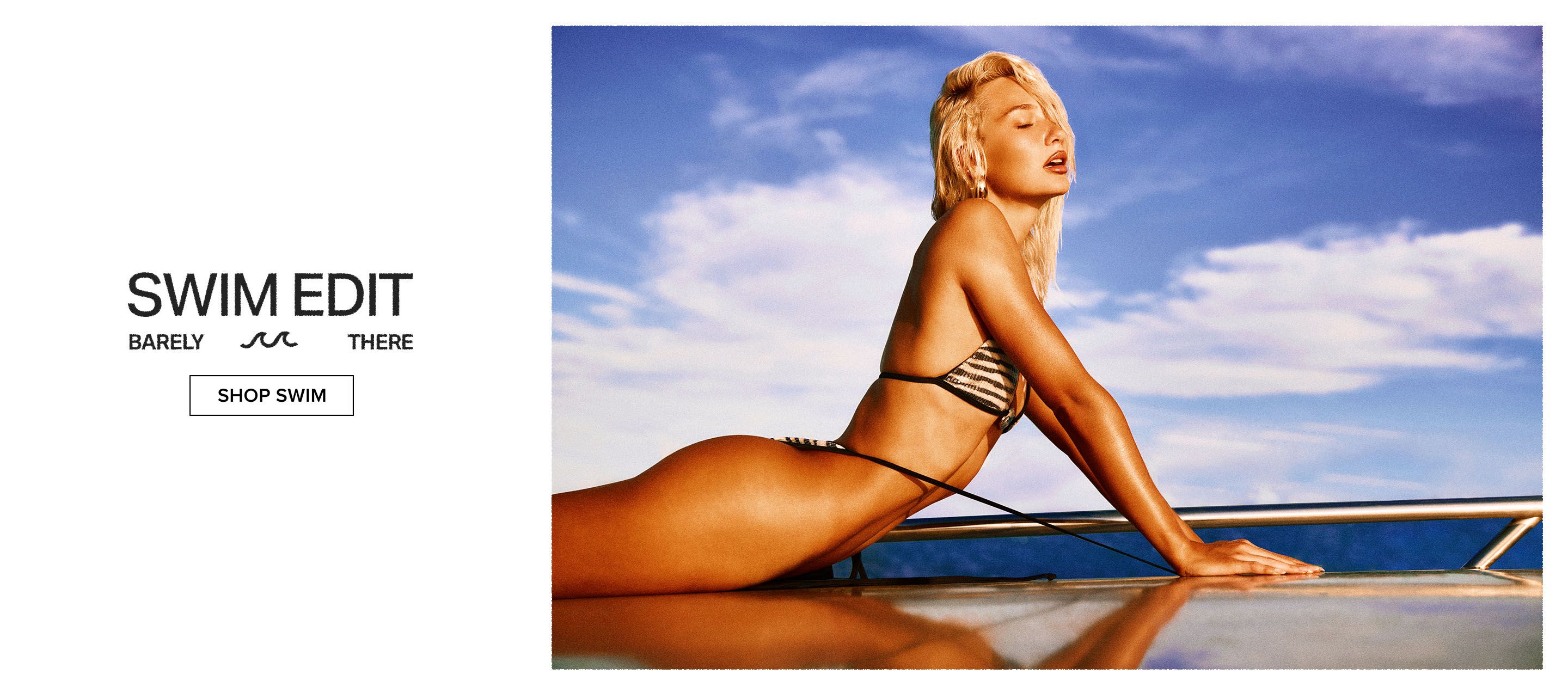 Blonde woman in striped bikini, sunkissed and reclining under a blue sky. Explore our new Barely There swim collection.