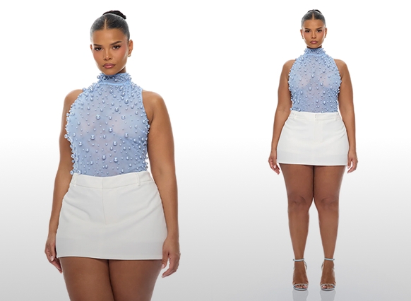 Model showcases a light blue beaded mesh sleeveless top with a high neck and white mini skirt, highlighting stylish new women's fashion.