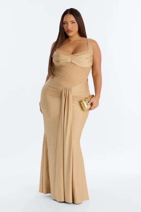 Radiant gold sequin gown with beaded shoulder draping on a model. This elegant full-length formal dress is ideal for evening events.