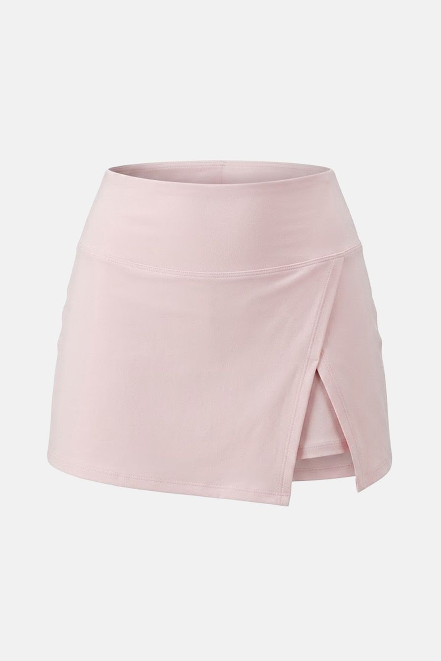Falda pantalón deportiva rosa claro de cintura alta con diseño tipo wrap y shorts integrados, ideal para tenis o yoga.