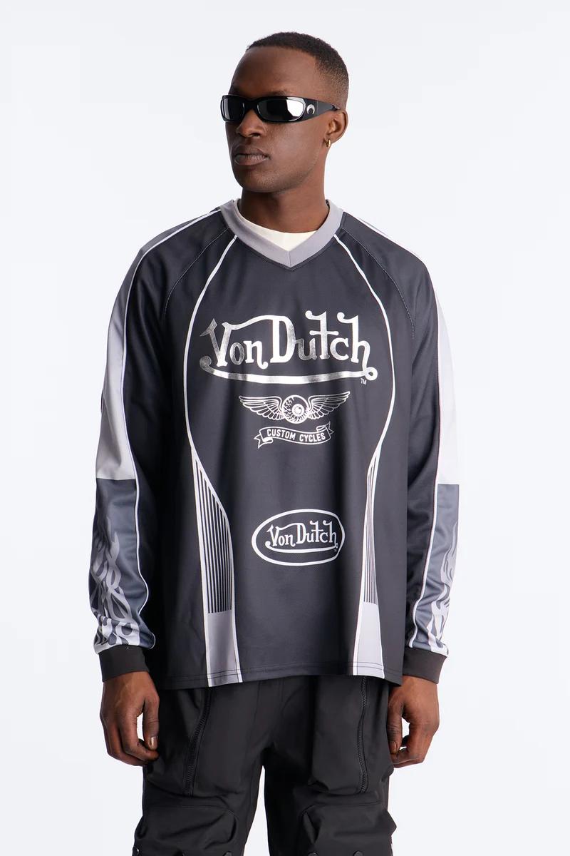 Man in black Von Dutch Custom Cycles long-sleeve shirt with silver details, black sunglasses, and cargo pants. New collection streetwear.