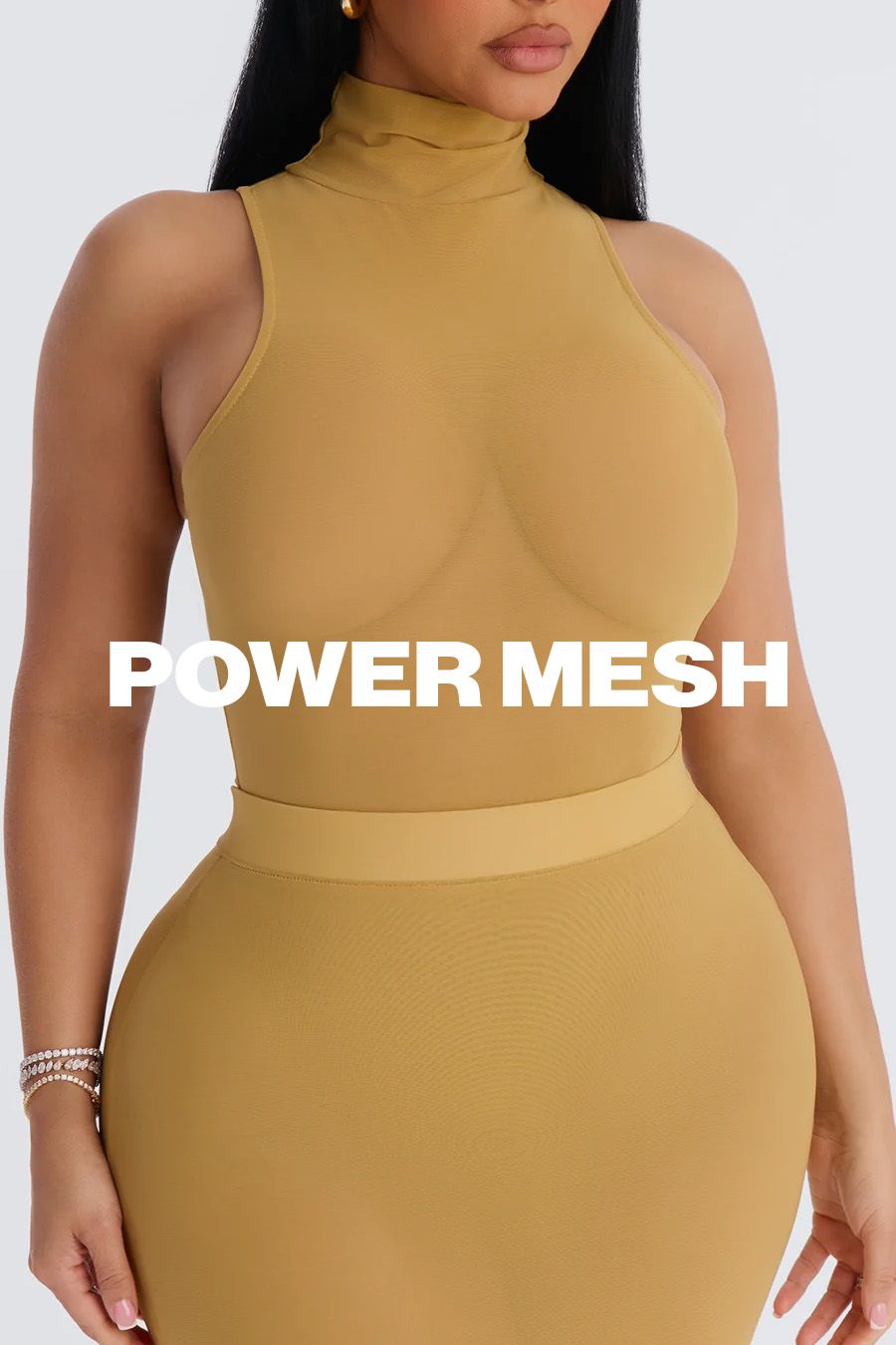 Woman in a fitted tan power mesh sleeveless turtleneck and matching skirt, highlighting the new collection's shaping fit.