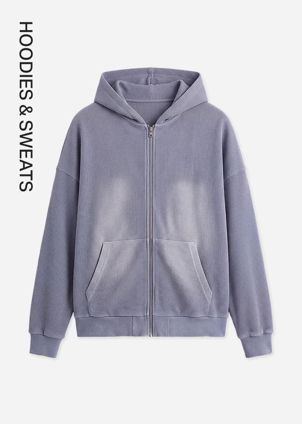 Dusty blue waffle knit zip-up hoodie featuring a faded wash, promoting the new cozy fleece hoodies and pants catalog collection.