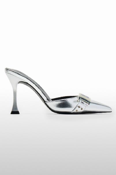 Shimmering silver metallic pointed-toe mule with a unique flared heel and decorative buckle strap, showcasing new heeled footwear.