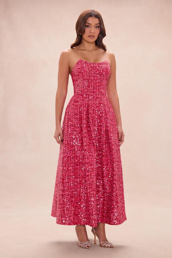 Full-length shot of a woman in a stunning pink sequin strapless midi dress, ideal for an elegant party or special occasion.