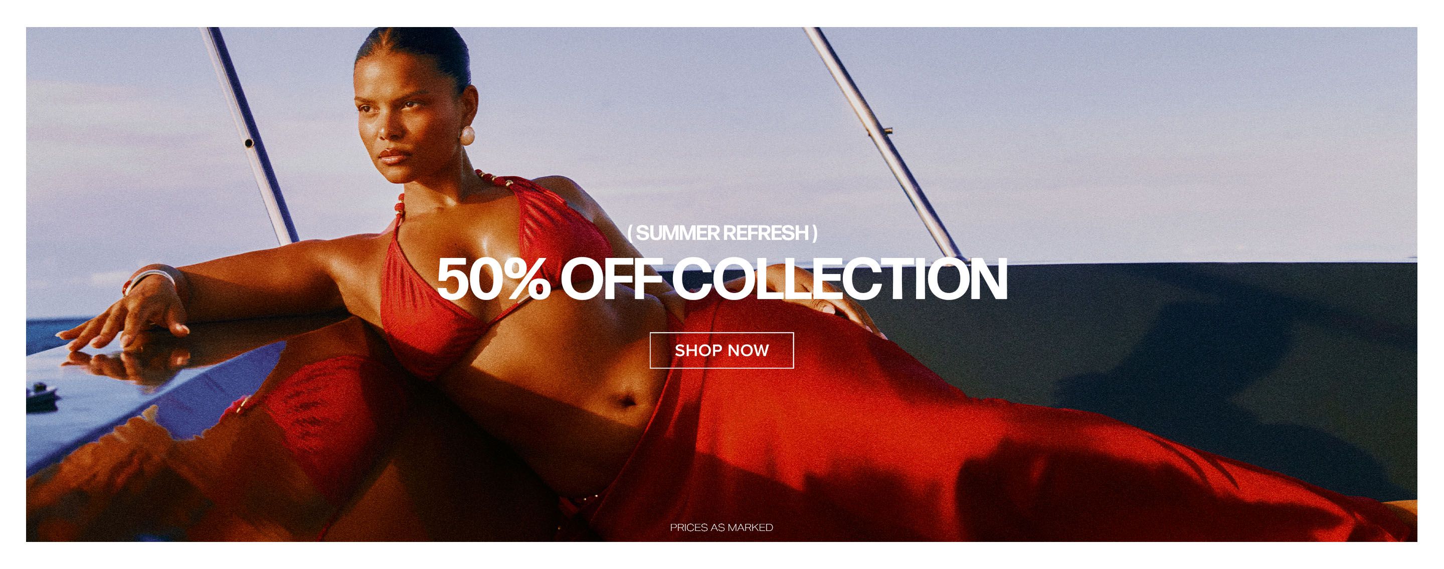 Confident woman in red bikini & sarong on boat, promoting a 50% off summer swimwear collection sale. Shop now!