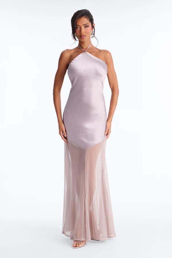 Woman in a light blue floor-length gown with a corset bodice & ruched V-neck. She holds a silver clutch and wears silver jewelry.