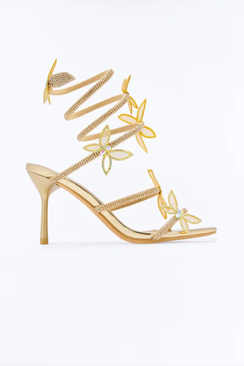 Gold spiral high heel sandals with crystal butterfly embellishments.