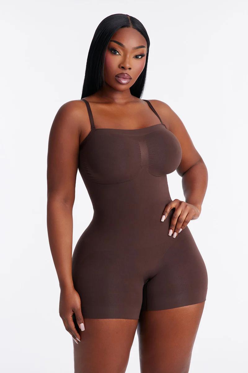 Confident woman in a dark brown full-body shapewear bodysuit, showcasing its curve-enhancing design and smooth compression for all-day comfort.