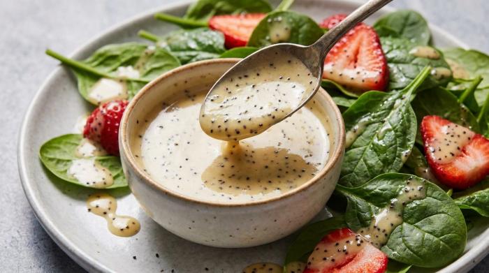 A glass jar filled with homemade poppyseed dressing.