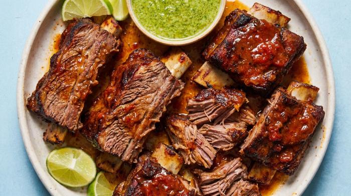 Tender Mexican beef short ribs smothered in a dark red chipotle sauce.