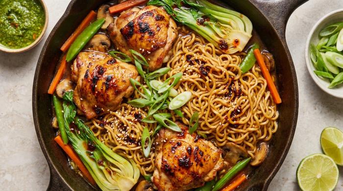 Overhead view of chicken and vegetable ramen noodles garnished with green onions.