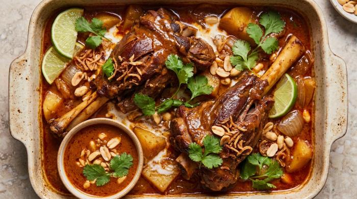 A deeply browned lamb shank smothered in rich massaman curry sauce