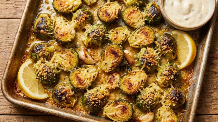 Crispy roasted Brussels sprouts coated in parmesan and breadcrumbs, served in a bowl.