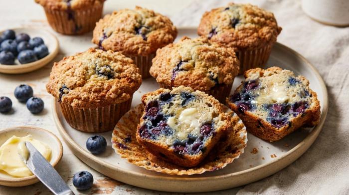 A stack of freshly baked blueberry muffins with golden brown tops.