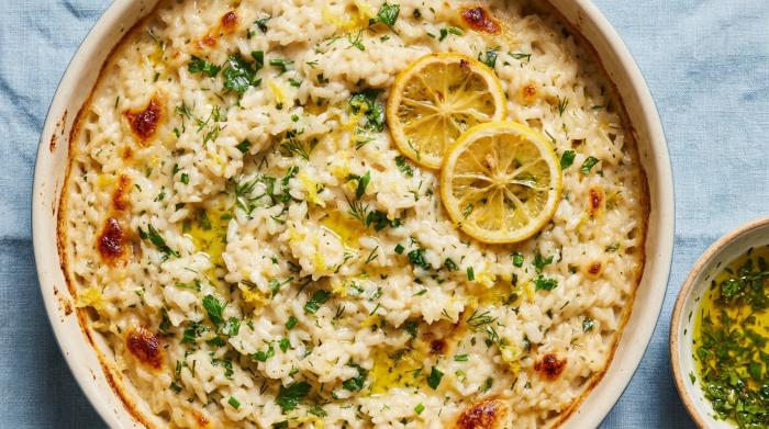 A serving of creamy lemon and herb baked risotto in a shallow bowl.