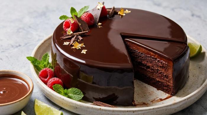 Whole chocolate mirror glaze cake reflecting light