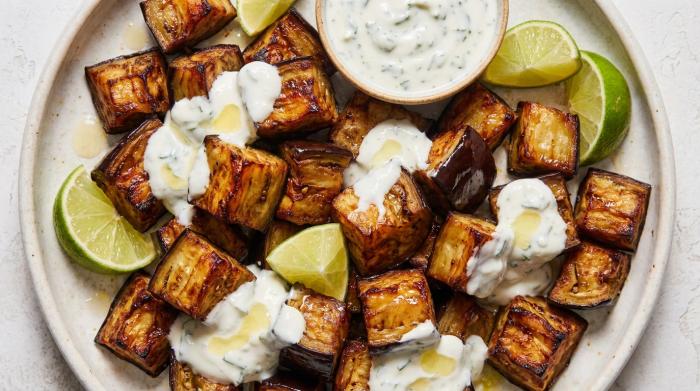 Perfectly caramelized roasted eggplant cubes served in a rustic bowl.