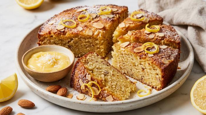 Whole lemon coconut almond cake topped with toasted almond flakes