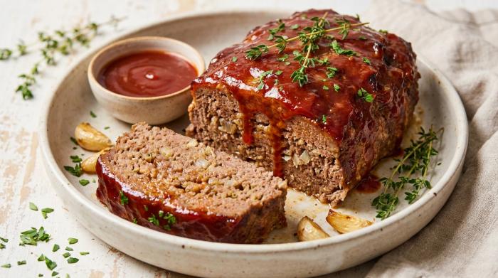 A slice of moist meatloaf coated in a sticky red glaze.