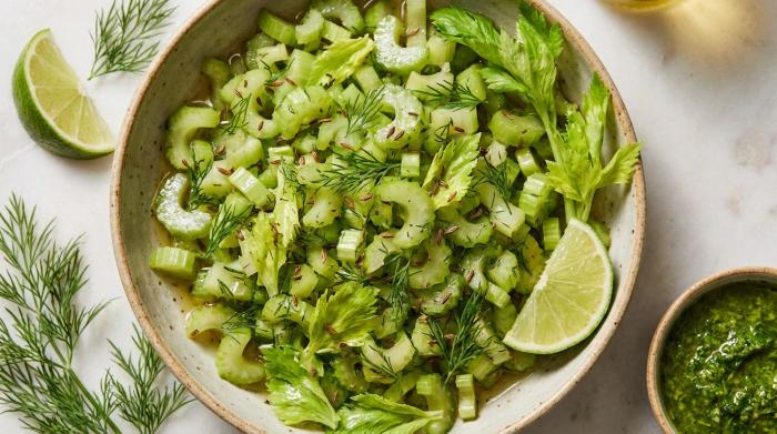 A bowl of leftover celery salad with fresh dill and caraway seeds.