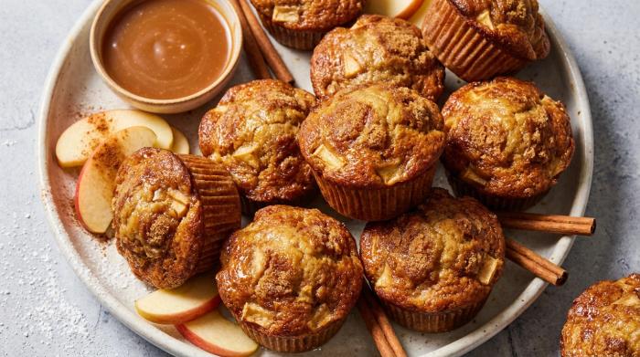 A stack of moist apple muffins topped with sparkling sugar.