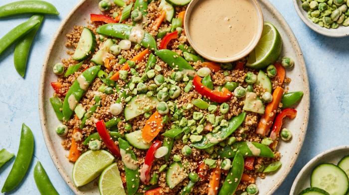 A large bowl of quinoa salad topped with crushed wasabi peas.
