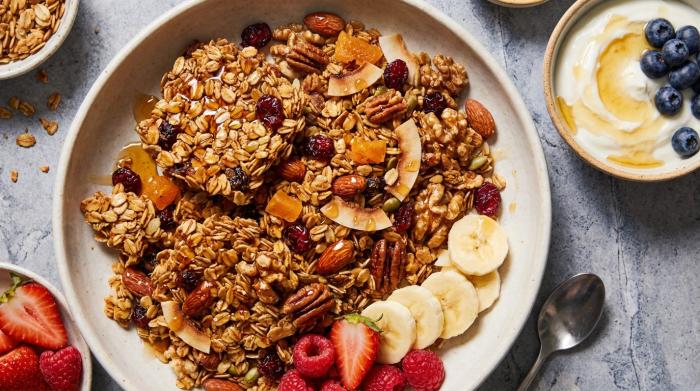 A serving bowl filled with mixed homemade granola.