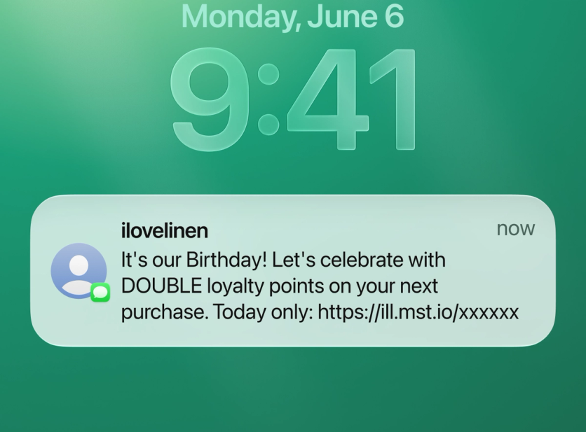 SMS notification on a phone lock screen: I Love Linen birthday message offering double loyalty points today only