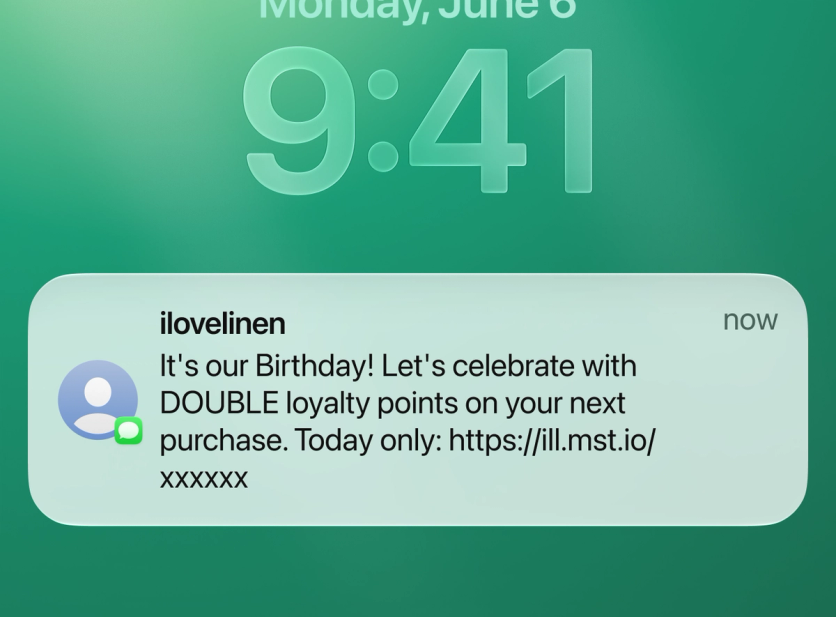 SMS notification on a phone lock screen: I Love Linen birthday message offering double loyalty points today only