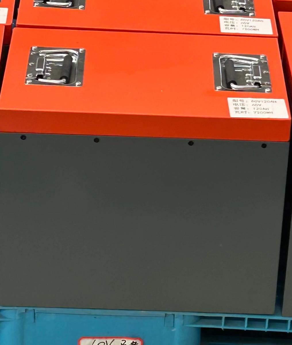 Front view of an orange-lid 60V 120Ah battery pack in its factory setting